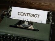 Smart Contract Security – Audits, Formal Verification, and Testing a close up of a typewriter with a sign that reads contact