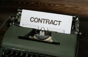 Smart Contract Security – Audits, Formal Verification, and Testing a close up of a typewriter with a sign that reads contact