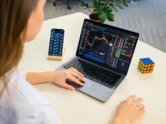 Building and Using Automated Crypto Trading Bots a woman sitting at a table using a laptop computer