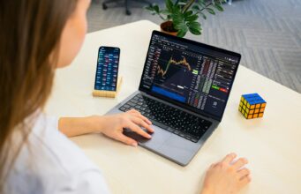 Building and Using Automated Crypto Trading Bots a woman sitting at a table using a laptop computer