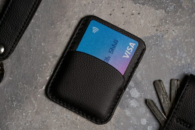 Photo by Ocult Store a black wallet with a credit card and keys