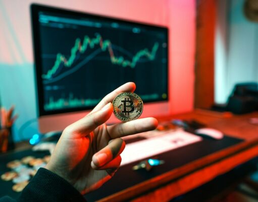 How to Build a Balanced Crypto Portfolio – Risk, Diversification, and Strategy a person holding a coin in front of a computer