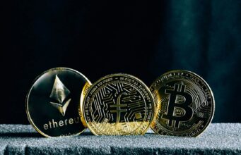 Understanding Blockchain – The Foundation of Cryptocurrency Investing three bitcoins sitting on top of a table