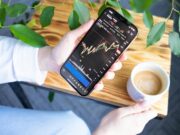 Trading Crypto Futures and Options for Income a person holding a cell phone in their hand