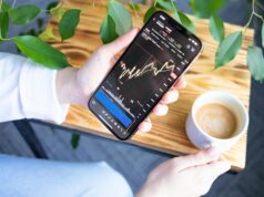 Trading Crypto Futures and Options for Income a person holding a cell phone in their hand