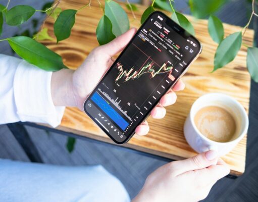 Trading Crypto Futures and Options for Income a person holding a cell phone in their hand